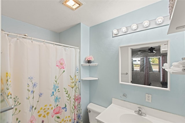 bathroom with a shower with curtain, vanity, and toilet