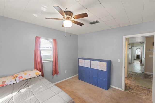 carpeted bedroom with multiple windows and ceiling fan