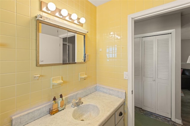 bathroom featuring tasteful backsplash, vanity, and tile walls