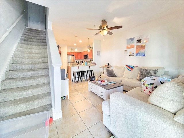 living room with light tile patterned flooring and ceiling fan