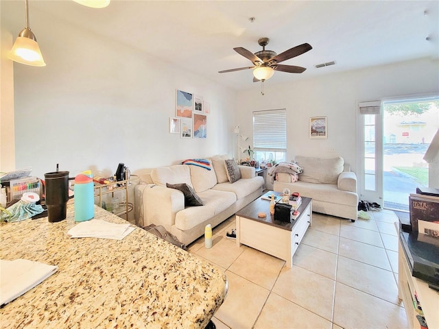 tiled living room featuring ceiling fan