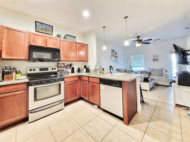 kitchen with sink, decorative light fixtures, light tile patterned floors, appliances with stainless steel finishes, and kitchen peninsula