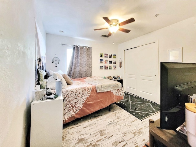 bedroom with ceiling fan, a closet, and light wood-type flooring