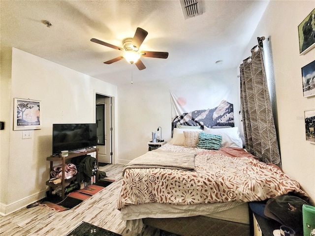 bedroom featuring hardwood / wood-style flooring and ceiling fan