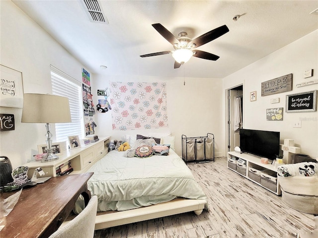 bedroom with ceiling fan and light wood-type flooring