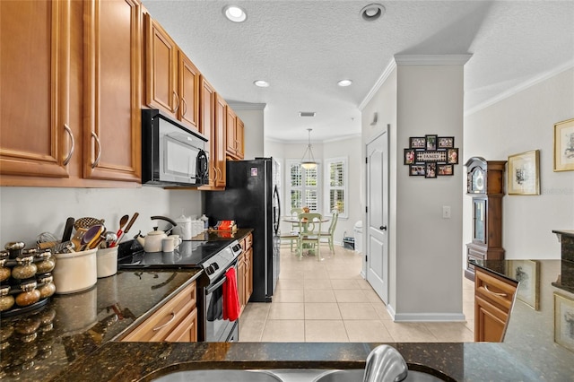 kitchen featuring light tile patterned flooring, pendant lighting, ornamental molding, black appliances, and a textured ceiling