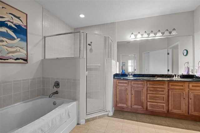 bathroom featuring vanity, tile patterned flooring, independent shower and bath, and a textured ceiling