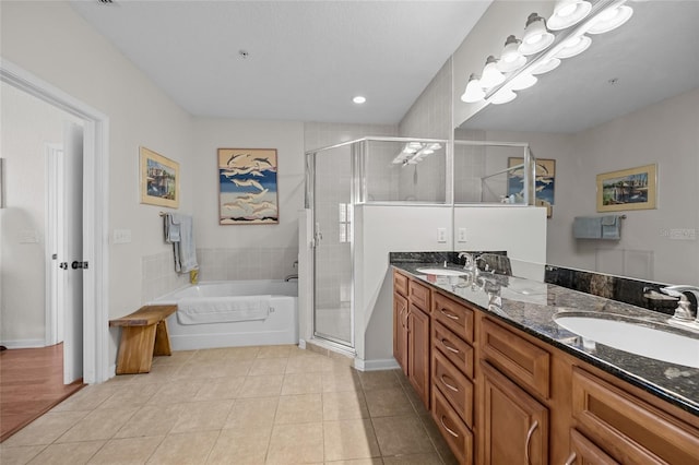 bathroom with tile patterned flooring, vanity, and separate shower and tub