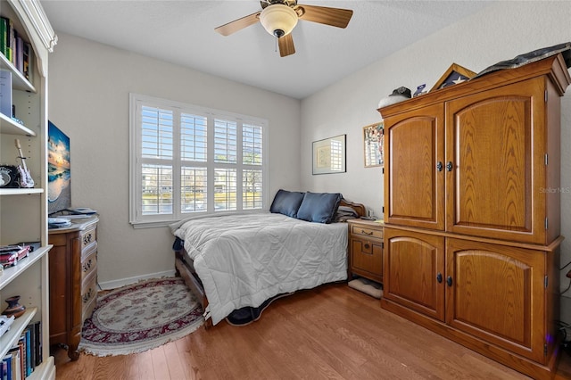 bedroom featuring ceiling fan and light hardwood / wood-style flooring