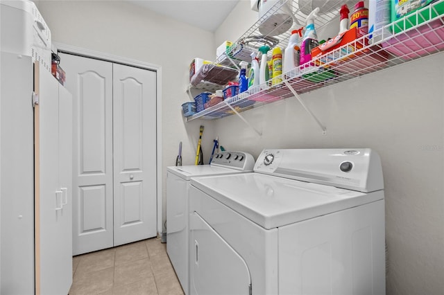 washroom with separate washer and dryer and light tile patterned flooring