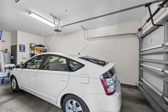 garage featuring a garage door opener and water heater