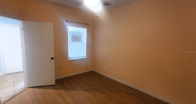 unfurnished room with a healthy amount of sunlight and light hardwood / wood-style floors