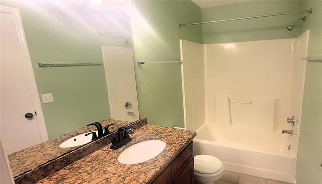 full bathroom featuring vanity, tile patterned flooring, toilet, and washtub / shower combination