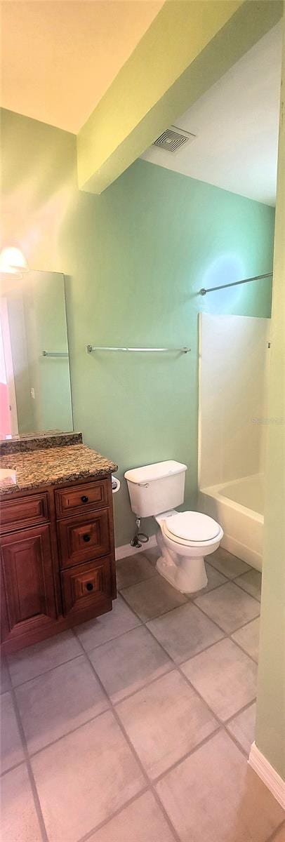 bathroom with shower / tub combination, tile patterned floors, and toilet