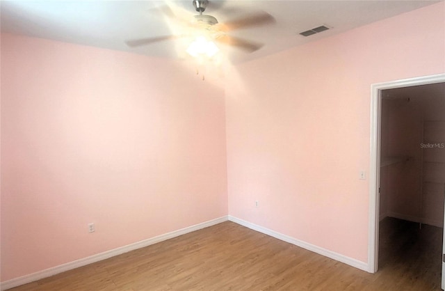 empty room with light hardwood / wood-style flooring and ceiling fan