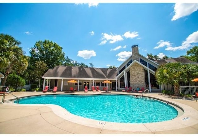 view of swimming pool with a patio