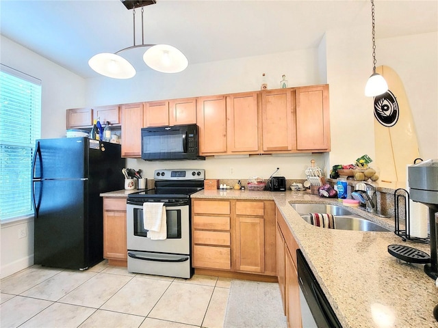 kitchen with a healthy amount of sunlight, sink, pendant lighting, and black appliances