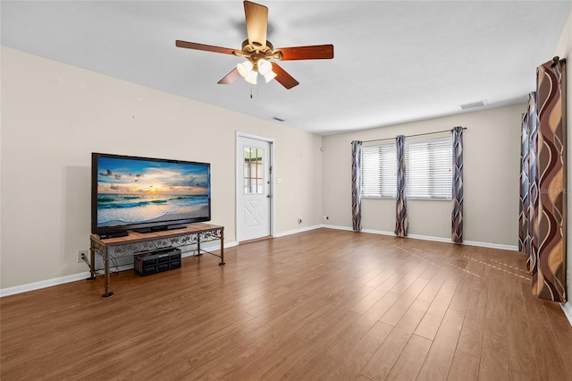 living room with hardwood / wood-style flooring and ceiling fan