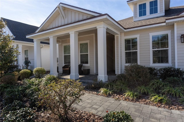 view of exterior entry with a porch