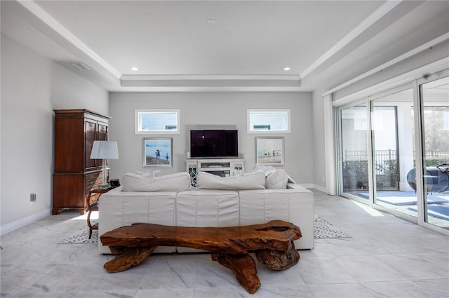 living room featuring ornamental molding and a tray ceiling