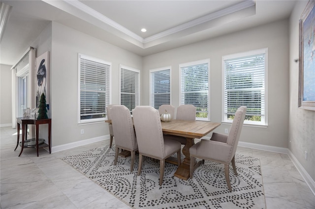 dining area featuring crown molding and a tray ceiling