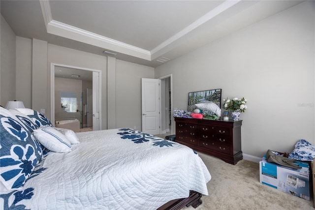 carpeted bedroom with a tray ceiling