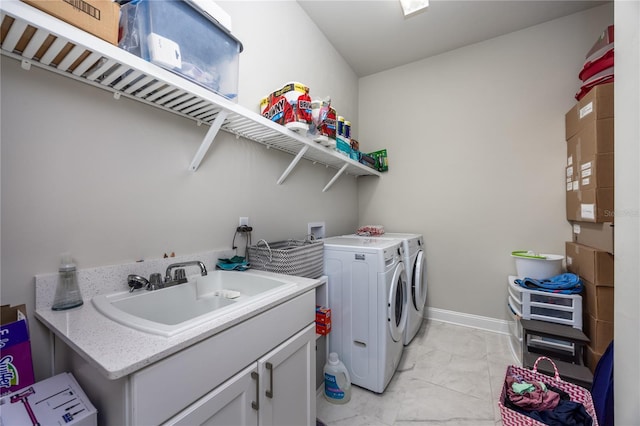 laundry area with cabinets, sink, and washing machine and clothes dryer