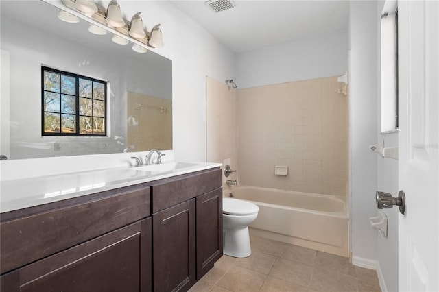 full bathroom featuring tile patterned flooring, vanity, tiled shower / bath combo, and toilet