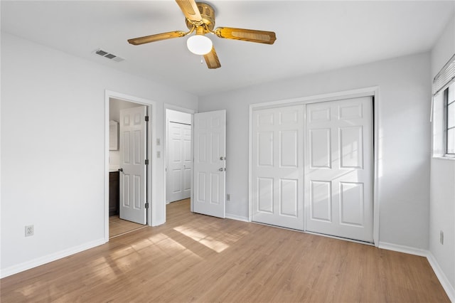 unfurnished bedroom with ceiling fan, ensuite bathroom, light hardwood / wood-style floors, and a closet