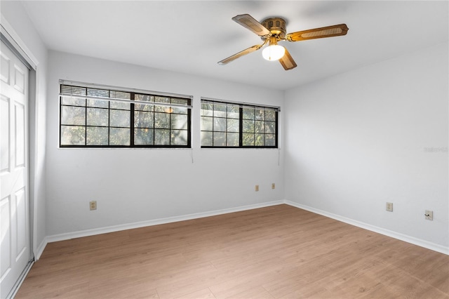 empty room with ceiling fan and light wood-type flooring