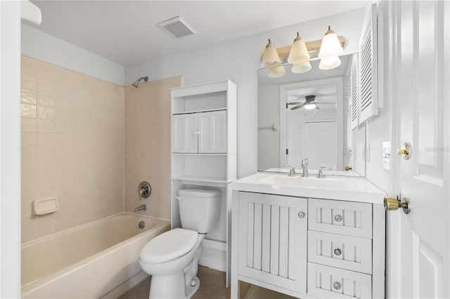 full bathroom with tiled shower / bath, vanity, and toilet