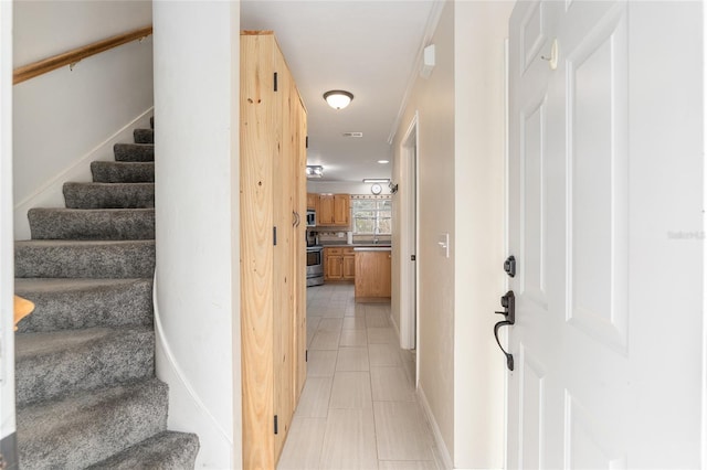 staircase featuring tile patterned flooring