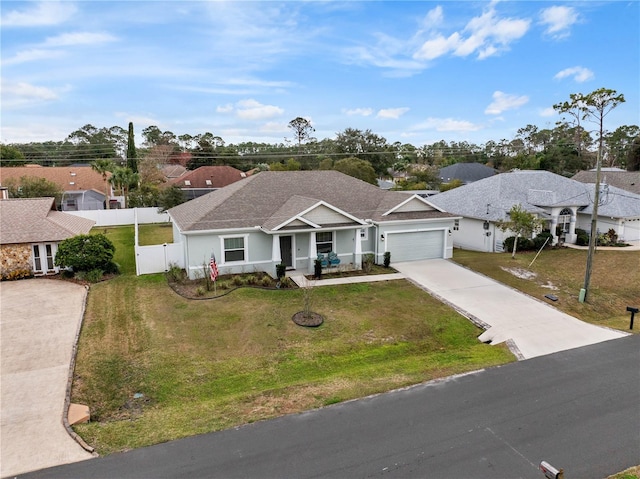 single story home featuring a garage and a front lawn