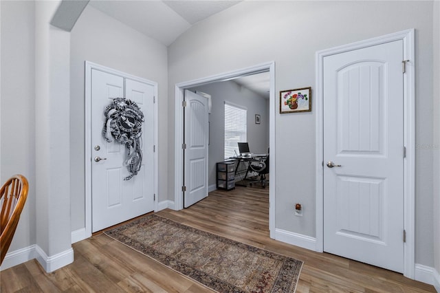 entryway with hardwood / wood-style floors