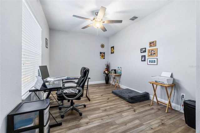 office with ceiling fan and light hardwood / wood-style flooring