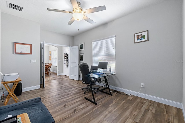 office area featuring dark wood-type flooring and ceiling fan