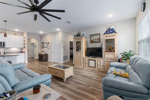 living room with hardwood / wood-style floors and ceiling fan