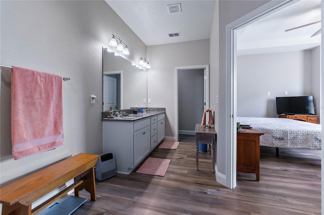 bathroom with hardwood / wood-style flooring, vanity, and ceiling fan