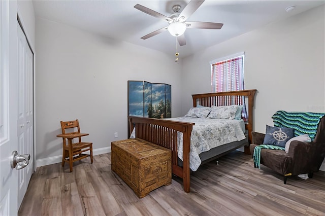 bedroom featuring ceiling fan, light hardwood / wood-style floors, and a closet