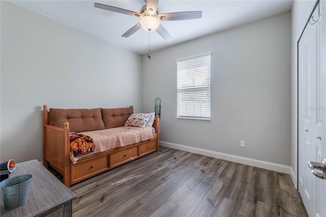 bedroom featuring ceiling fan and dark hardwood / wood-style floors