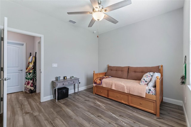 living area featuring wood-type flooring and ceiling fan