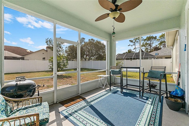 sunroom with ceiling fan and a wealth of natural light