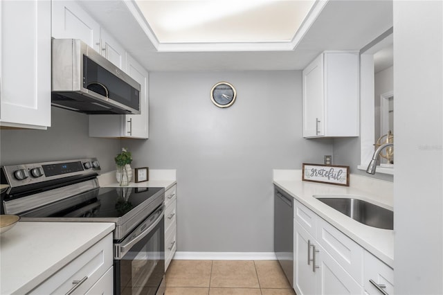 kitchen with appliances with stainless steel finishes, sink, and white cabinets