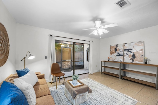 living room featuring light tile patterned floors and ceiling fan