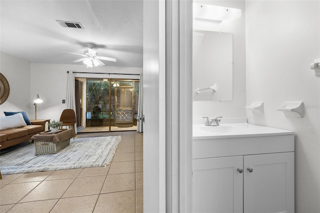 bathroom with tile patterned flooring, vanity, and ceiling fan