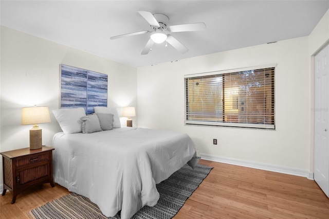 bedroom with light hardwood / wood-style flooring and ceiling fan