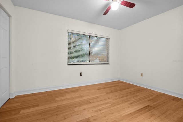 unfurnished bedroom with ceiling fan and wood-type flooring