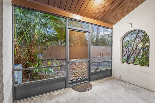 unfurnished sunroom featuring lofted ceiling