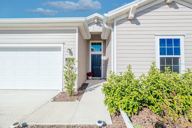 view of exterior entry with a garage