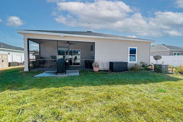 back of house featuring a yard, ceiling fan, and a patio area